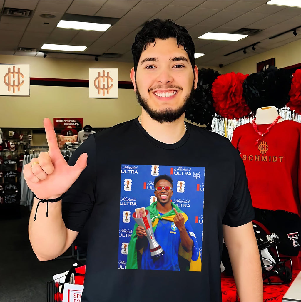 Vinicius Jr holding trophy middle finger shirt