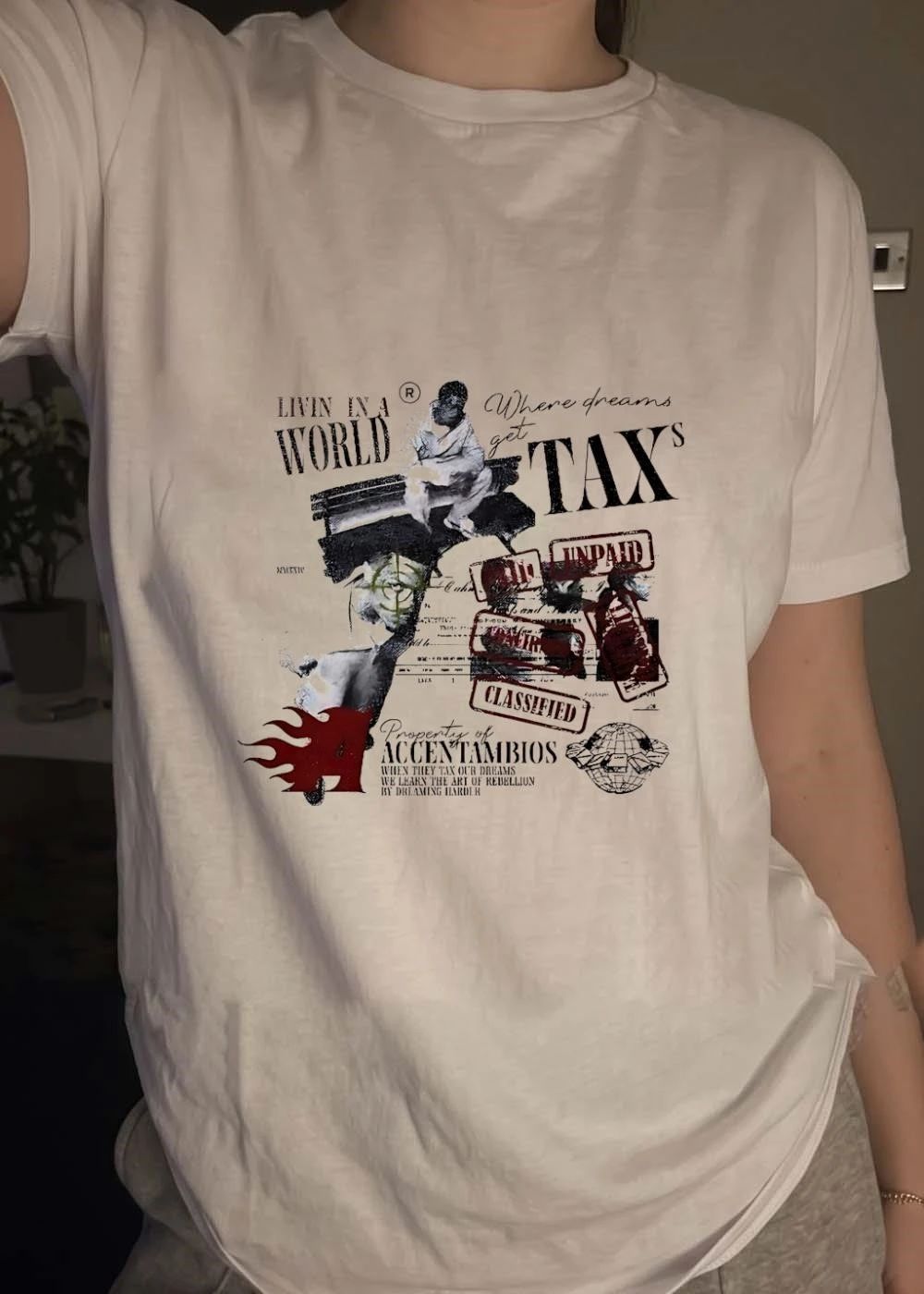 Property of Accentambios Man Sitting Livin in a World Where Dreams get Taxs Unpaid Classified T-Shirt