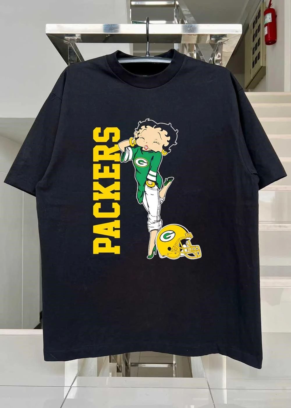 Betty Winking and Leaning on Helmet Packers shirt