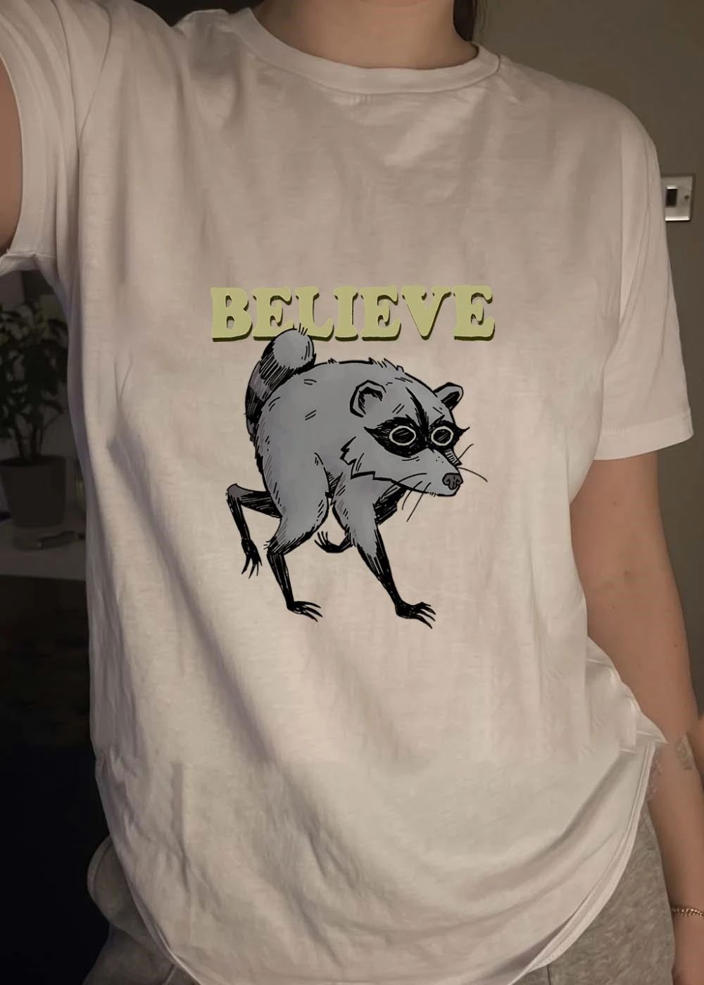 Believe Raccoon Walking Funny Animal Illustration T-Shirt